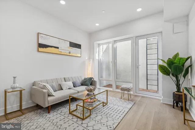 a living room with furniture and a potted plant