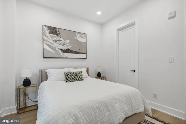 a bedroom with a bed and a painting on the wall