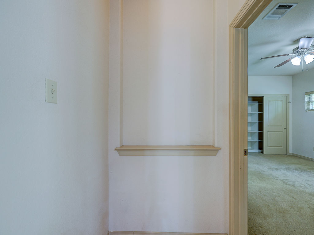 9707 Anderson Mill Road, Unit 22 Austin, TX 78750 - Photo 28 of 39 A peek into a cozy space with soft carpeting and a classic ceiling fan.