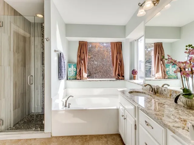 a bathroom with a tub sink and mirror