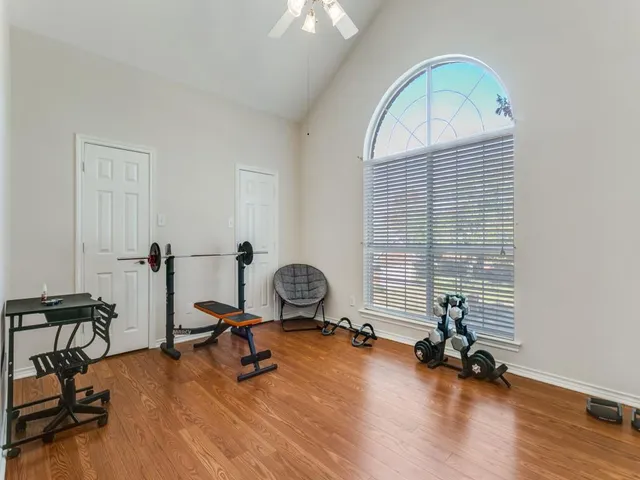 a view of a room with gym equipment and a window