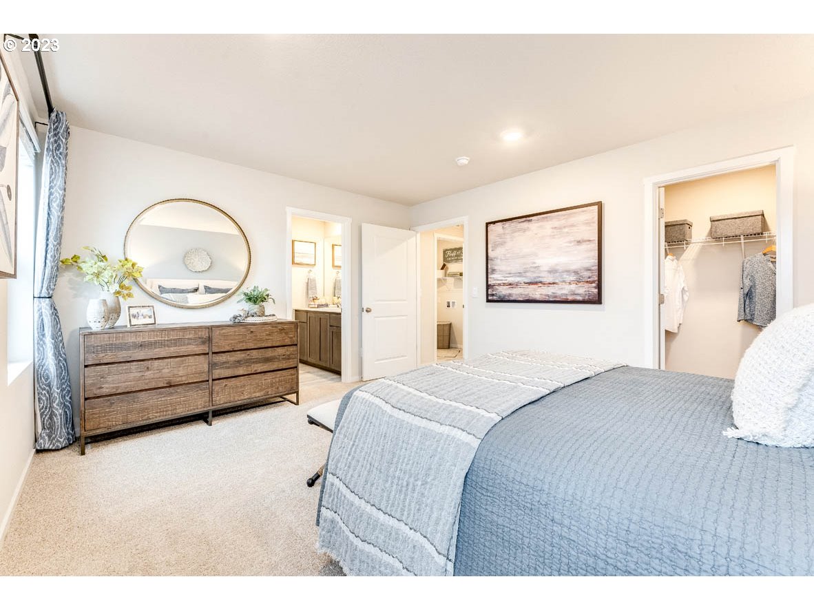 17510 Northwest 10th Avenue Ridgefield, WA 98642 - Photo 22 of 26 a bedroom with a bed a dresser and large mirror