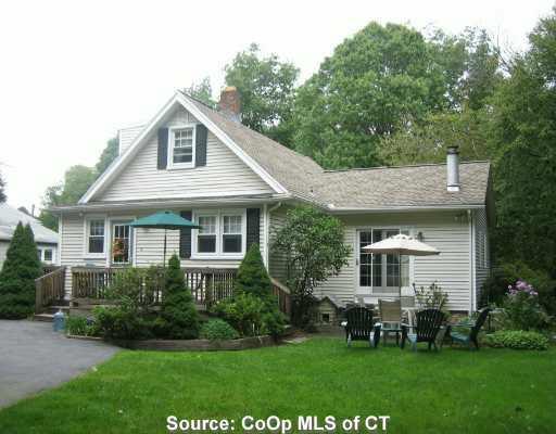 338 Smith Farm Road Orange, CT 06477 - Photo 1 of 1 a front view of a house with a garden and trees