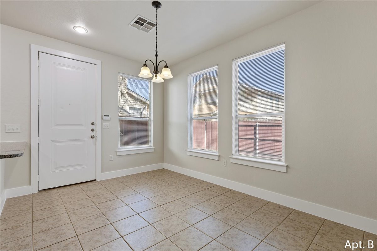 2225 Katy Lane, Unit B Georgetown, TX 78626 - Photo 6 of 22 Unfurnished dining area featuring hanging lights and light tile patterned floors