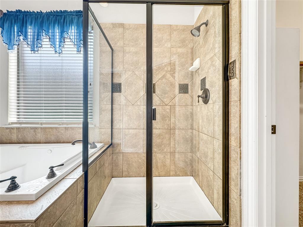 401 Varnum Way Fairview, TX 75069 - Photo 20 of 33 a bathroom with a tub and shower