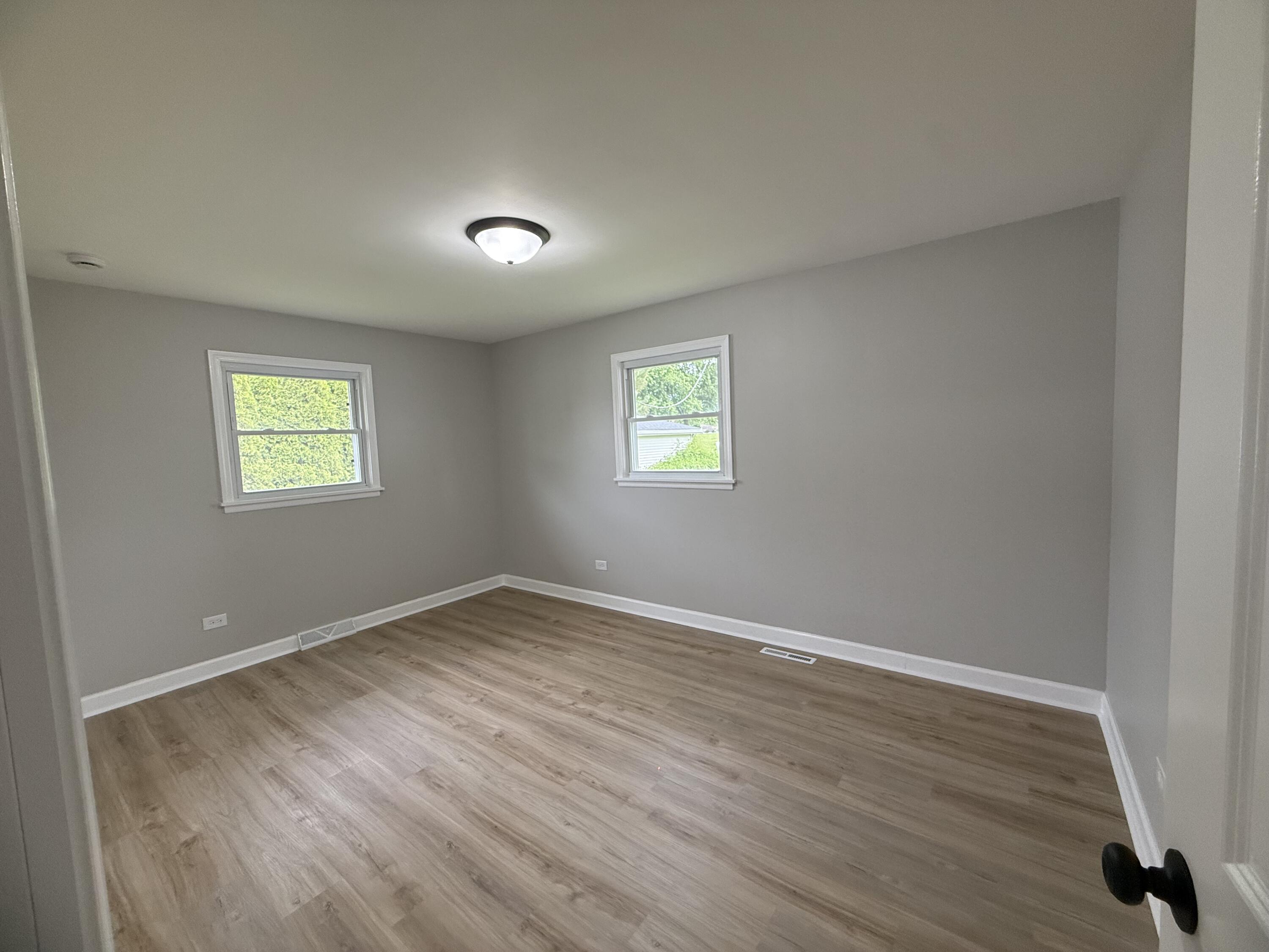 408 Cherry Hill Road Dyer, IN 46311 - Photo 14 of 31 a view of an empty room with wooden floor and a window