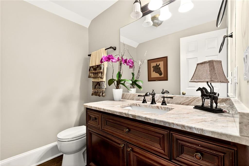 565 Old Lathemtown Road Canton, GA 30115 - Photo 18 of 73 a bathroom with a granite countertop sink a toilet and a mirror