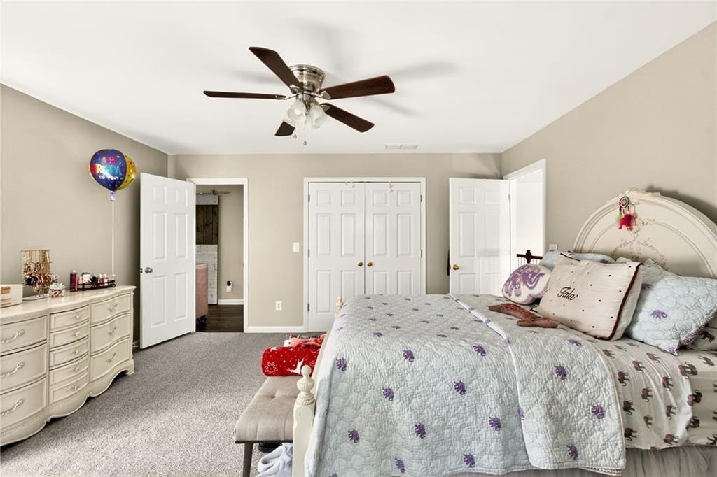 565 Old Lathemtown Road Canton, GA 30115 - Photo 35 of 73 a bedroom with a bed and a chandelier