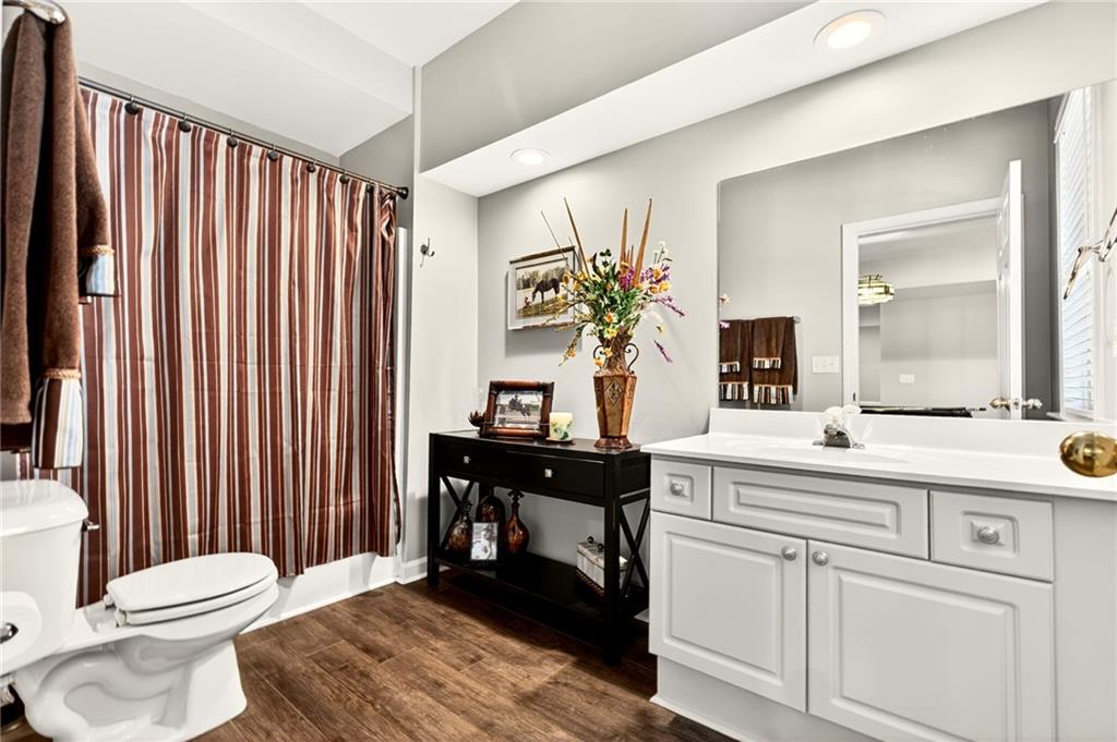 565 Old Lathemtown Road Canton, GA 30115 - Photo 46 of 73 a spacious bathroom with a sink a toilet and mirror