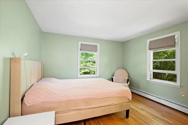 a large bed sitting in a bedroom next to a window