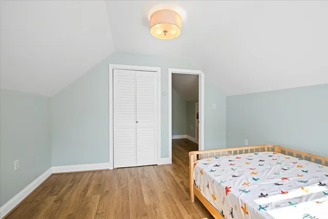 a view of a big room with wooden floor and cabinet