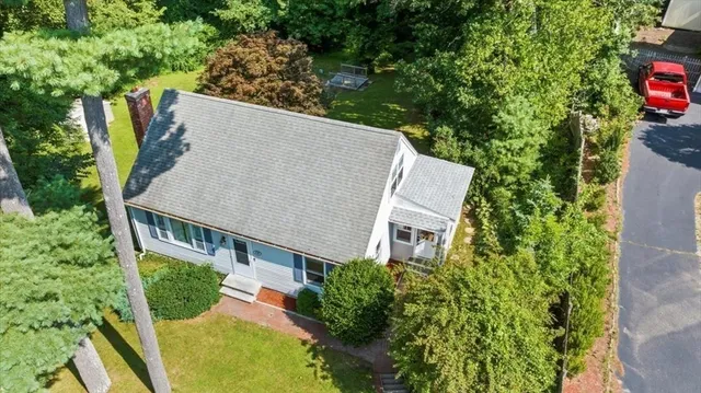 an aerial view of house with yard and outdoor seating