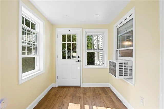 a view of an entryway with wooden floor and windows