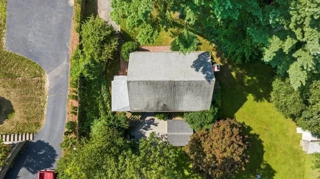 an aerial view of a house with garden space and street view