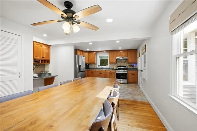 a dining room with furniture and a kitchen view