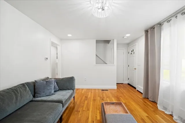 a living room with a couch and wooden floor