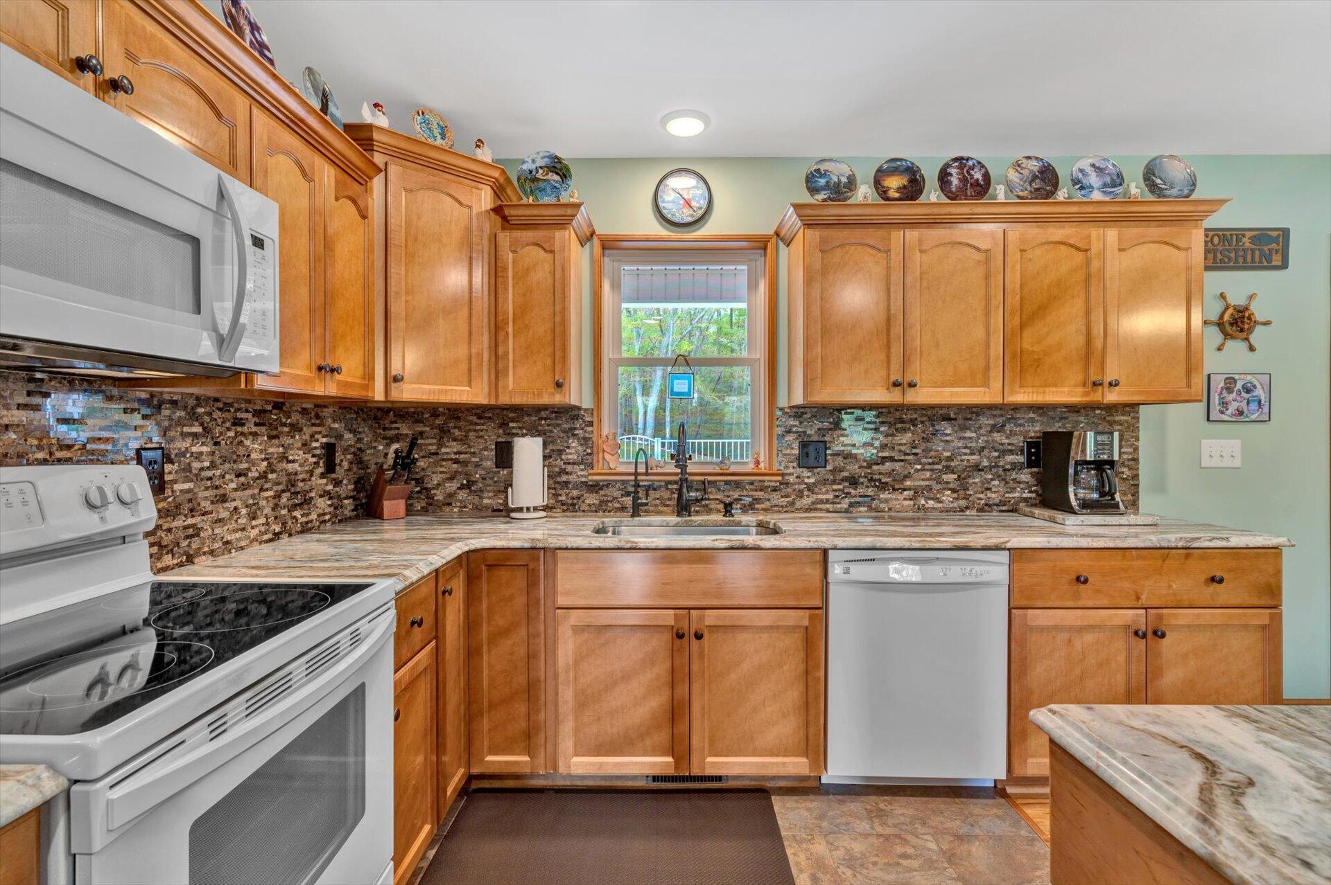 6 Highland Lake Road Union Hall, VA 24176 - Photo 16 of 56 a kitchen with granite countertop a sink a stove and cabinets