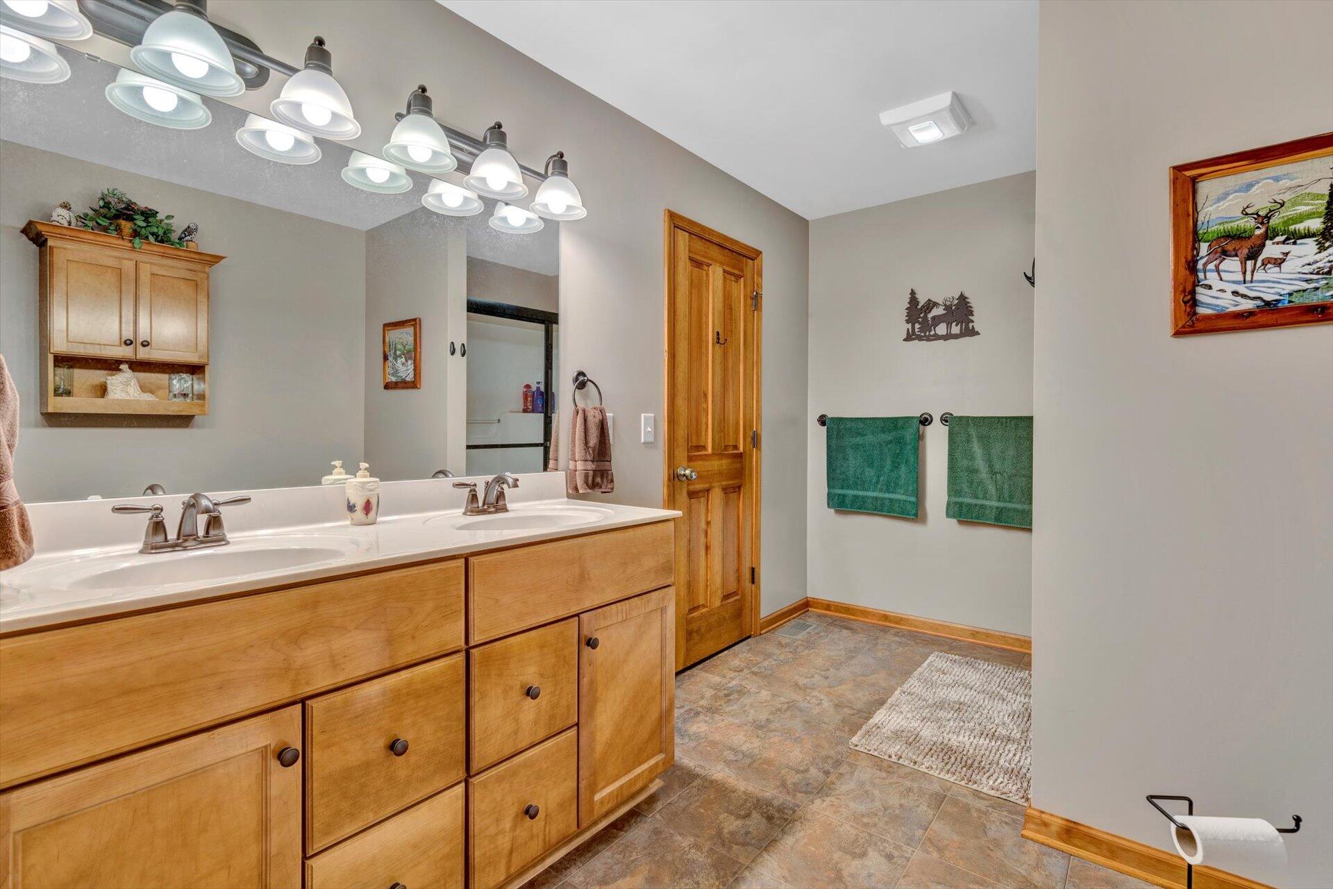 6 Highland Lake Road Union Hall, VA 24176 - Photo 25 of 56 a spacious bathroom with a granite countertop sink a large mirror and a shower