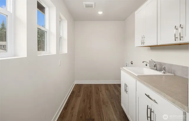 a view of a kitchen with sink and cabinets