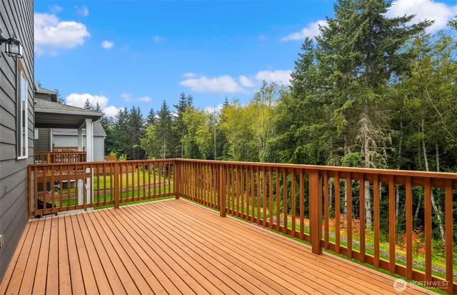 a view of balcony with wooden floor and fence