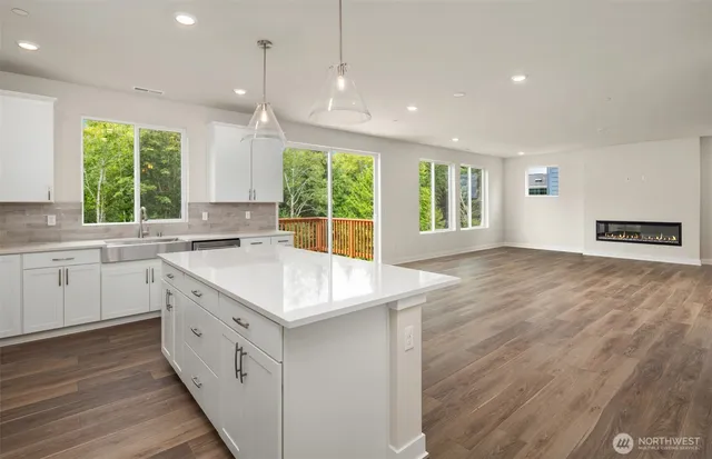 a kitchen with sink stove and cabinets