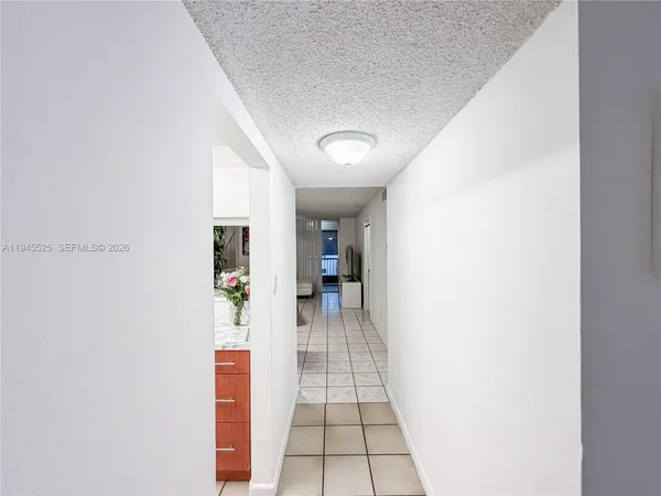 a view of a hallway view with wooden floor and living room