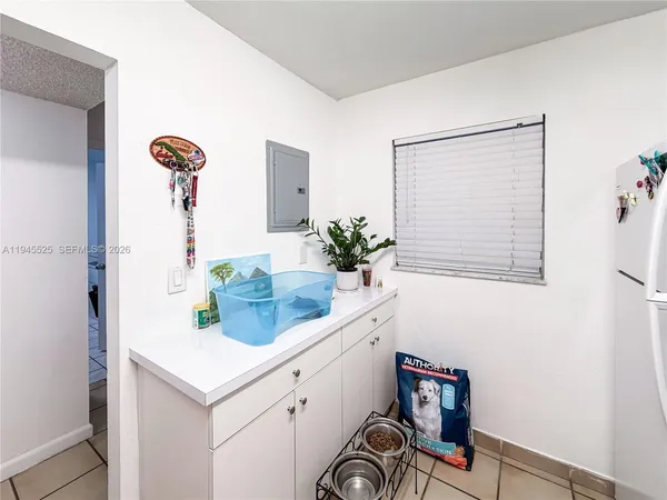 a room with a sink and a potted plant