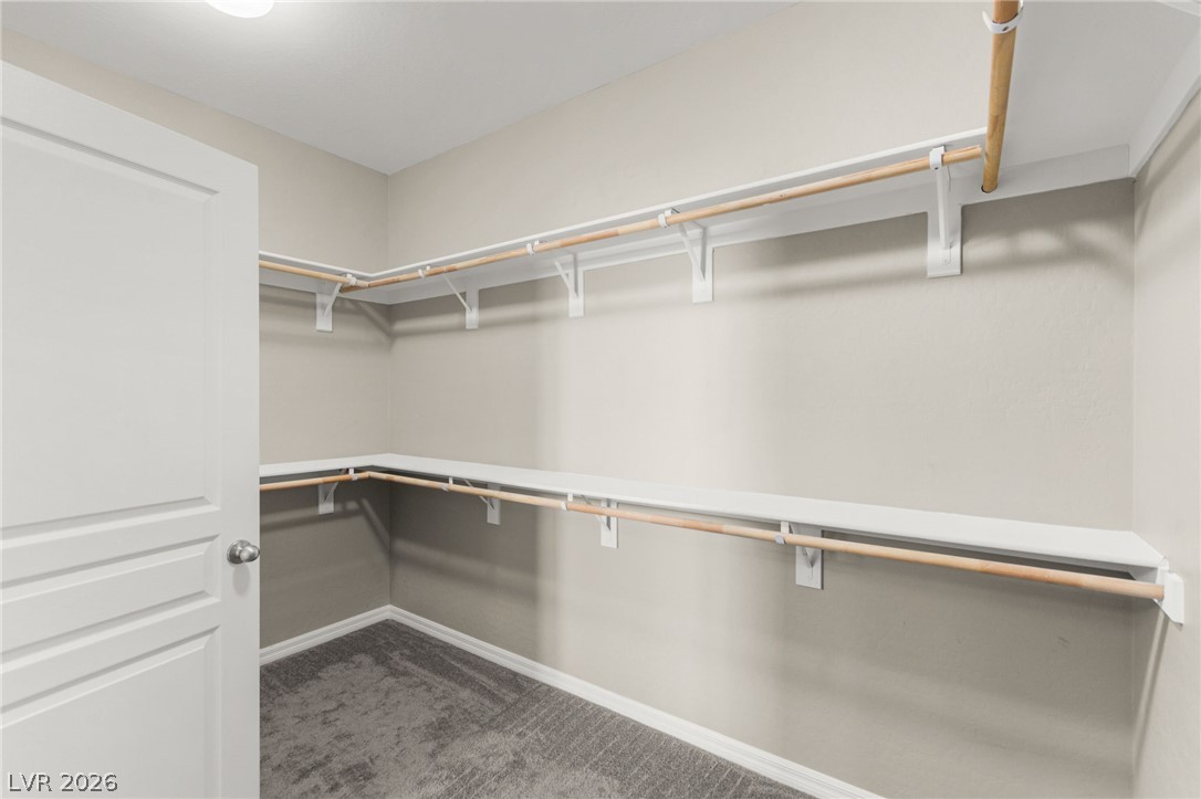 11048 Prairie Grove Road Las Vegas, NV 89179 - Photo 29 of 75 Customizable storage solutions await in this naturally illuminated walk-in closet.