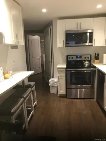 a kitchen with stainless steel appliances a stove a microwave and a sink
