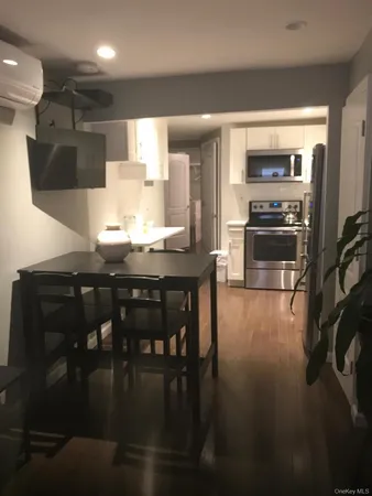 a kitchen with stainless steel appliances kitchen island granite countertop a stove a sink and a refrigerator