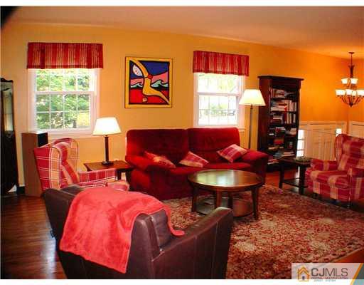 39 Clive Hills Road Edison, NJ 08820 - Photo 3 of 10 a living room with furniture a rug and a large window