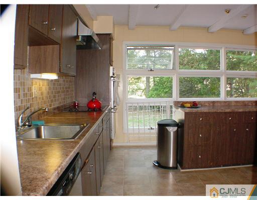39 Clive Hills Road Edison, NJ 08820 - Photo 5 of 10 a kitchen with kitchen island a counter top space and a sink
