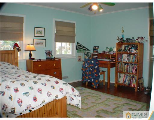 39 Clive Hills Road Edison, NJ 08820 - Photo 8 of 10 a bedroom with a bed and wooden floor