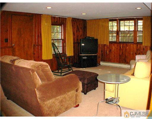 39 Clive Hills Road Edison, NJ 08820 - Photo 9 of 10 a living room with furniture and a floor to ceiling window