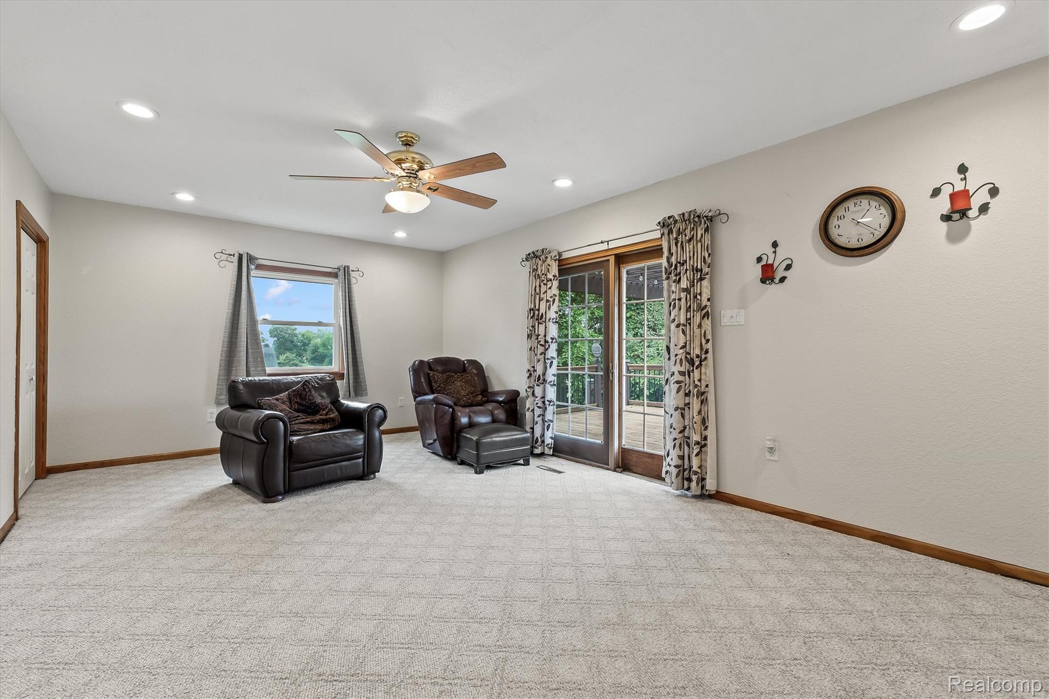 3553 North State Road Owosso, MI 48867 - Photo 19 of 45 Recessed lighting, ceiling fan with light fixture, patterned carpeting, and sliding glass door
