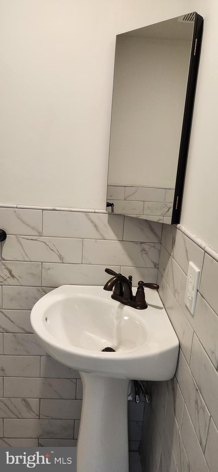 173 Washington Street Doylestown, PA 18901 - Photo 11 of 17 a bathroom with a sink and a mirror