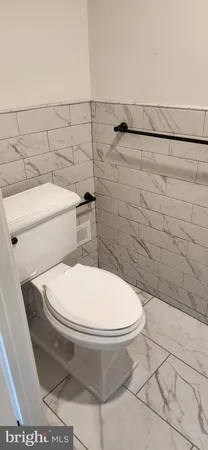 a white toilet sitting next to a shower and a sink