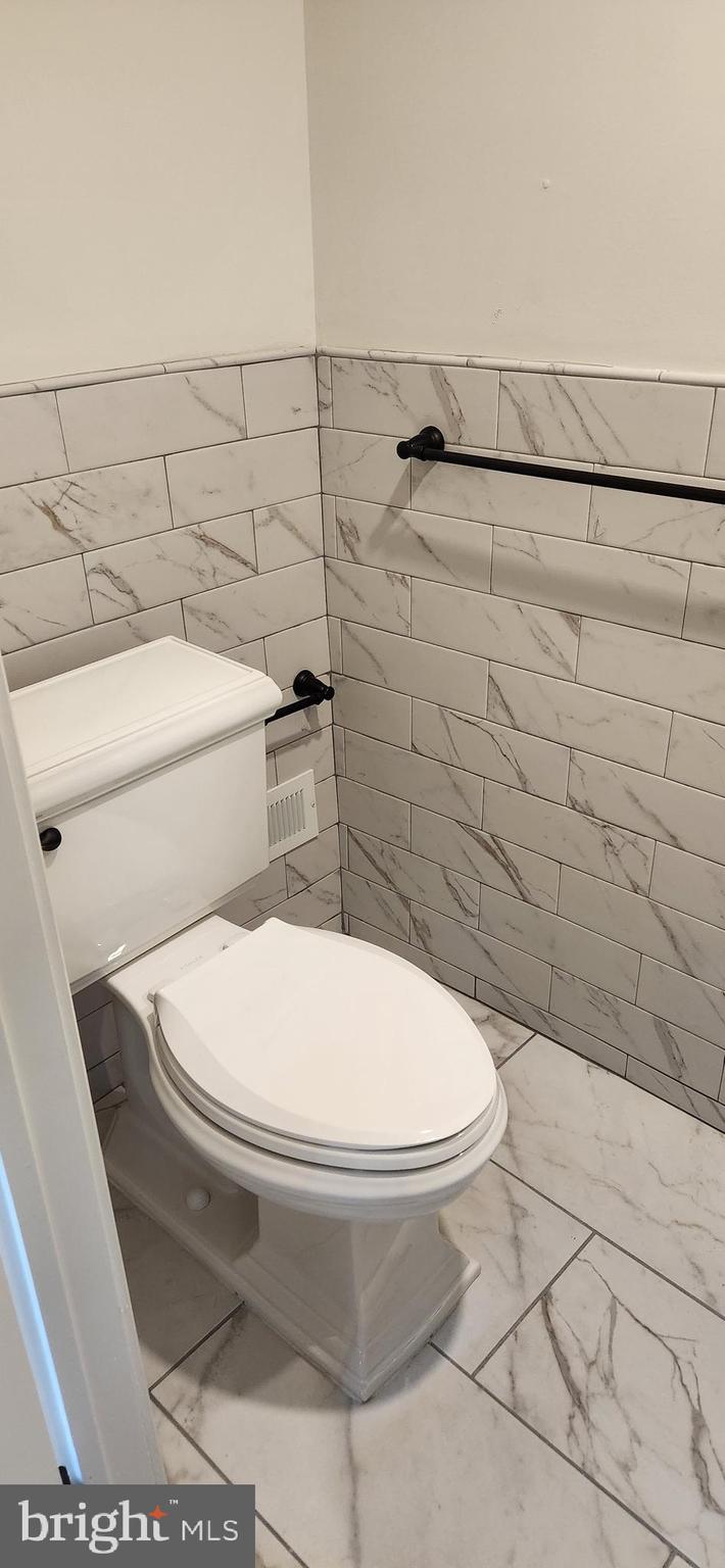 173 Washington Street Doylestown, PA 18901 - Photo 12 of 17 a white toilet sitting next to a shower and a sink