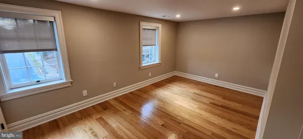 a view of room with window and wooden floor