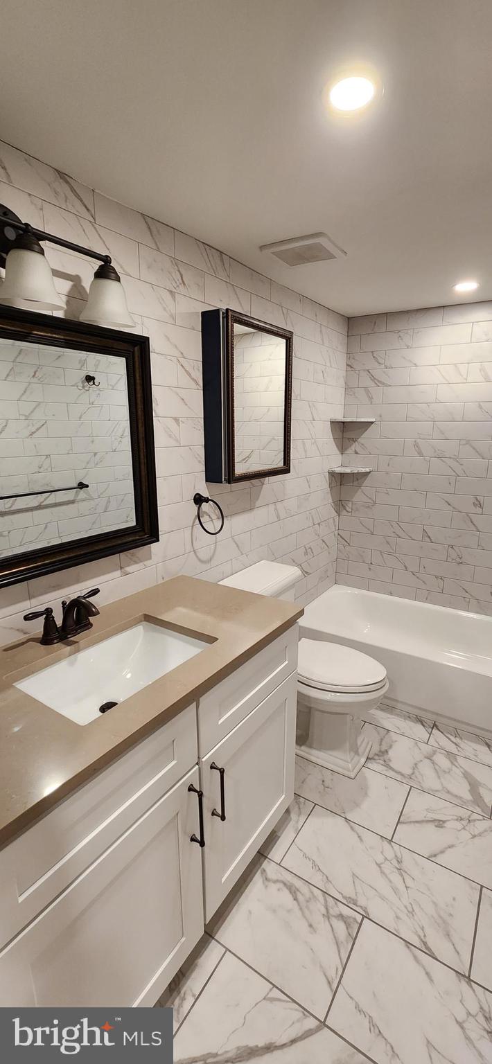 173 Washington Street Doylestown, PA 18901 - Photo 15 of 17 a bathroom with a sink a toilet and mirror
