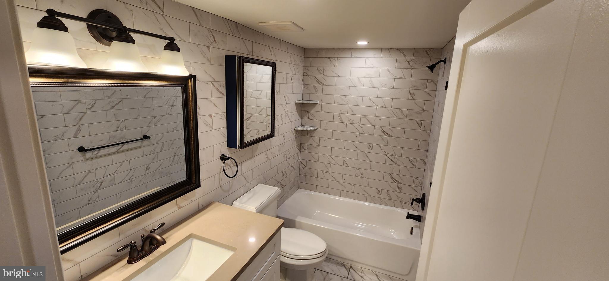 173 Washington Street Doylestown, PA 18901 - Photo 16 of 17 a bathroom with a shower a toilet and a sink