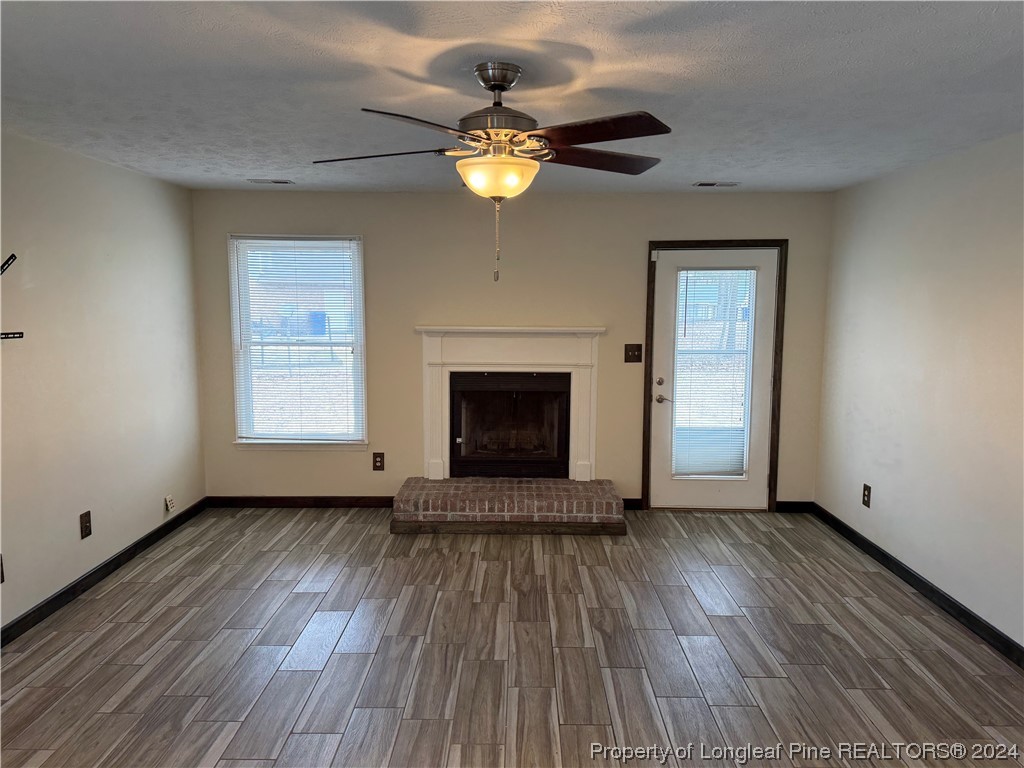 819 Rim Road Fayetteville, NC 28314 - Photo 20 of 42 a view of an empty room with wooden floor fireplace and a window
