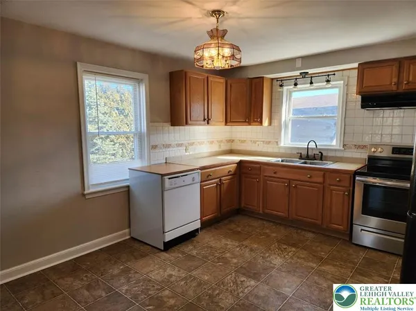 a kitchen with a sink stove and microwave