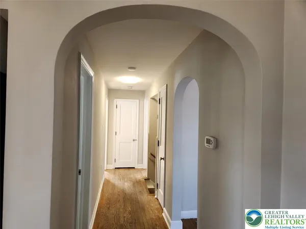 a view of a hallway with a bathroom