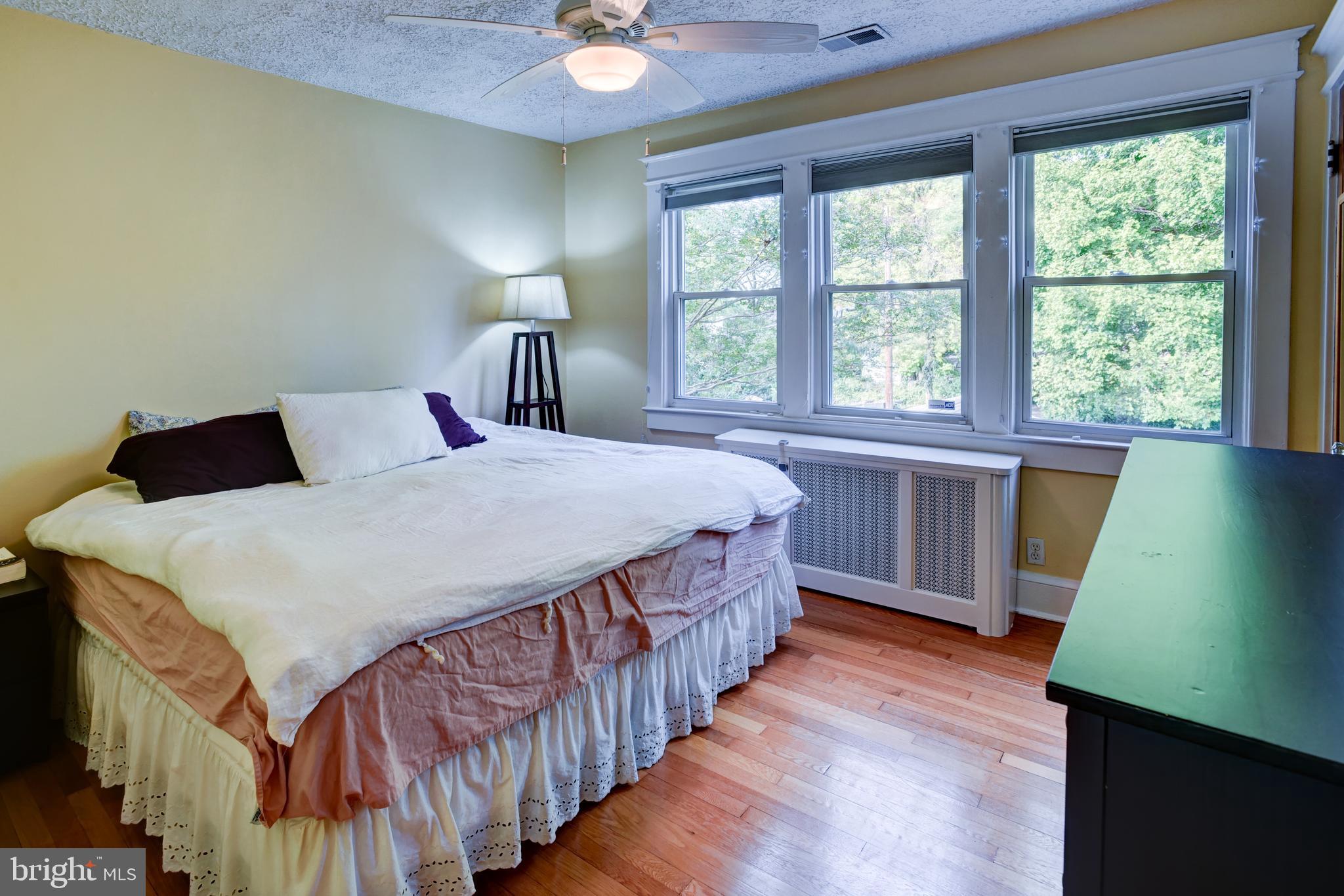 7216 7th Street Northwest Washington, DC 20012 - Photo 12 of 26 a bedroom with a bed a window with wooden floor