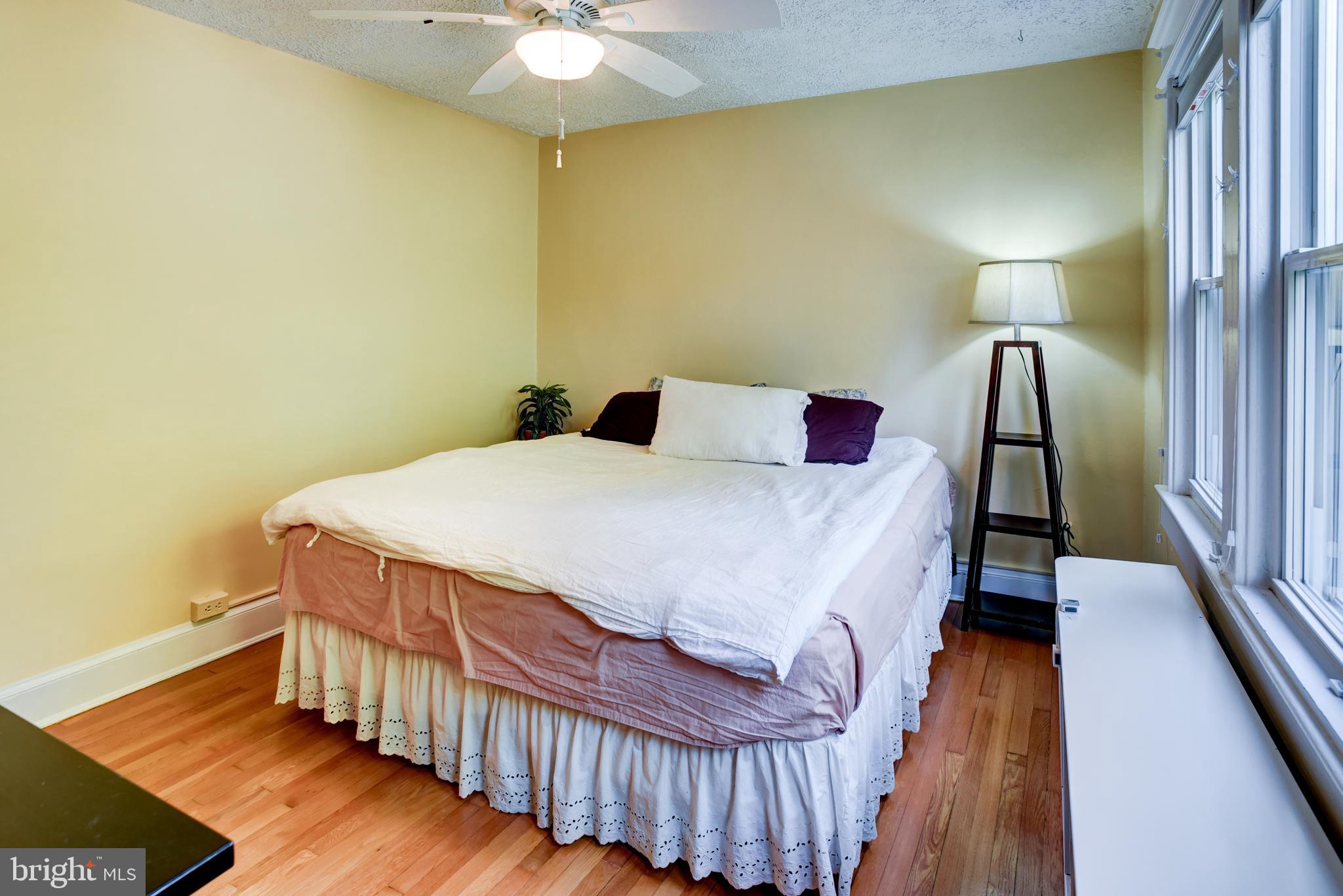 7216 7th Street Northwest Washington, DC 20012 - Photo 13 of 26 a bedroom with a bed and wooden floor