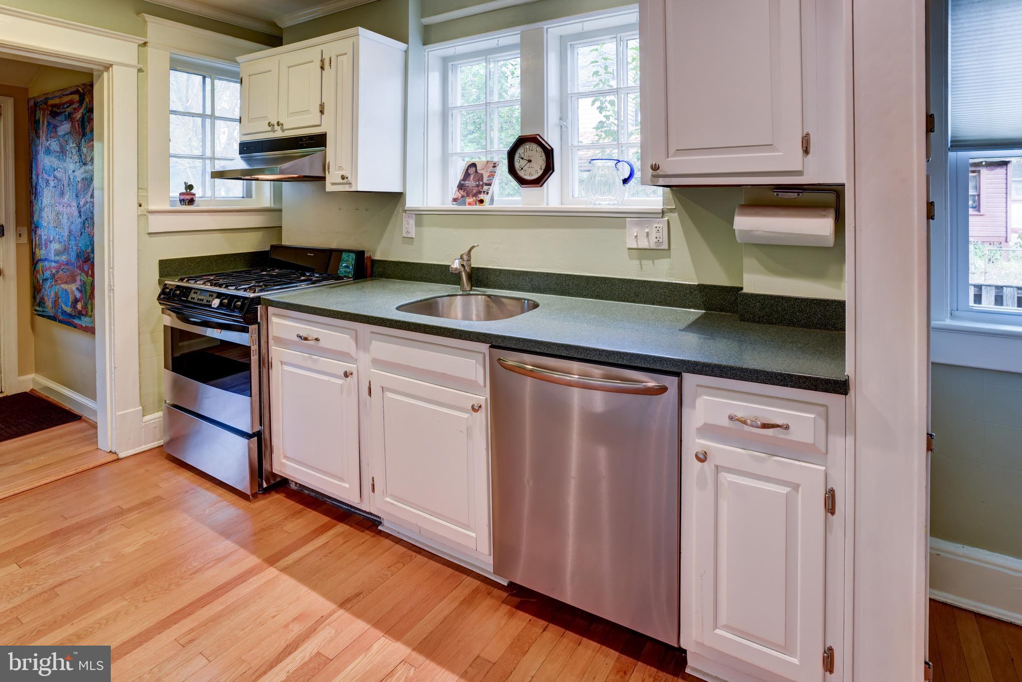 7216 7th Street Northwest Washington, DC 20012 - Photo 9 of 26 a kitchen with stainless steel appliances granite countertop a stove a sink and a microwave