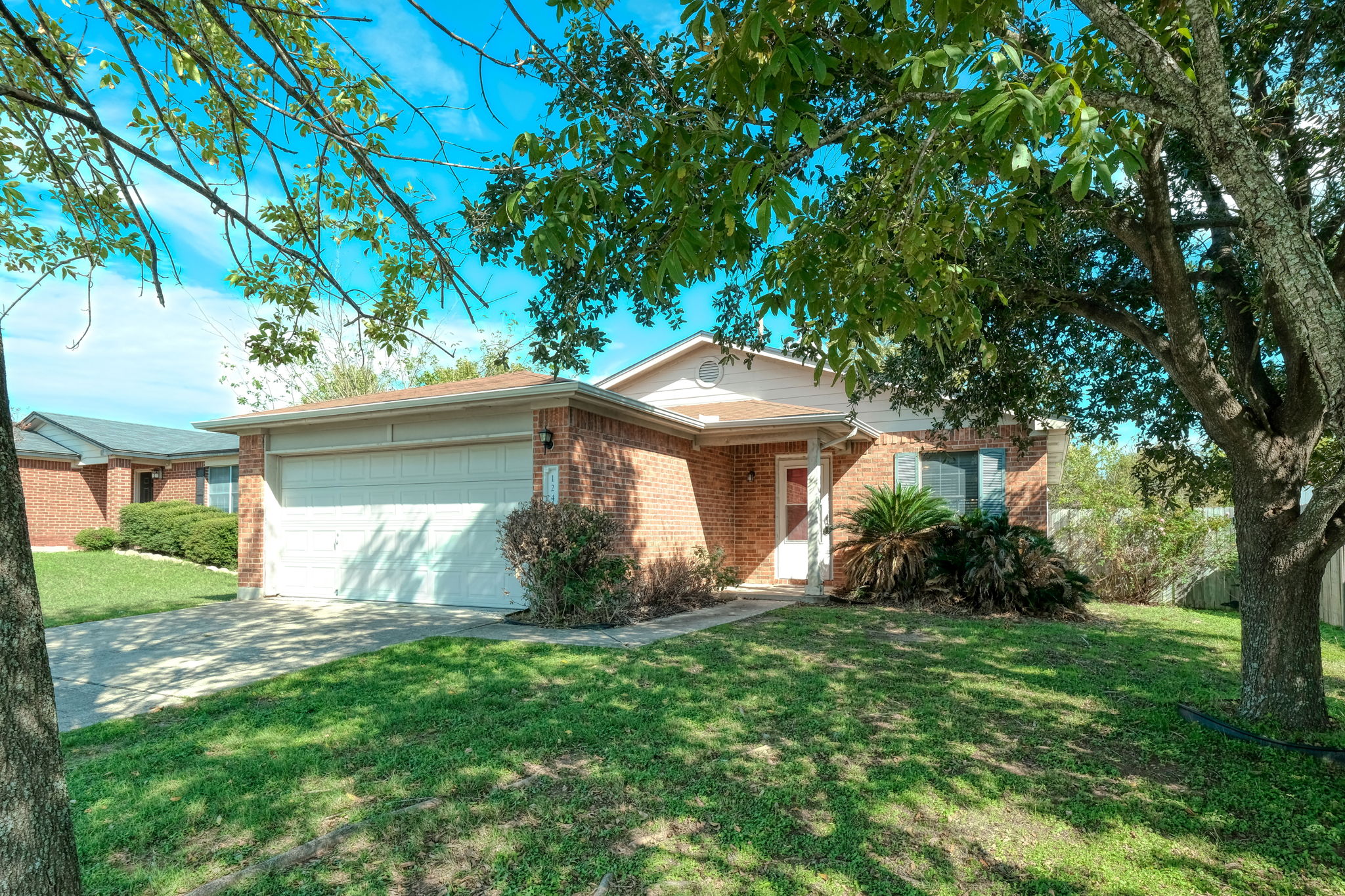 124 Hunter Rex Way Kyle, TX 78640 - Photo 1 of 14 Brick facade home with an attached two-car garage
