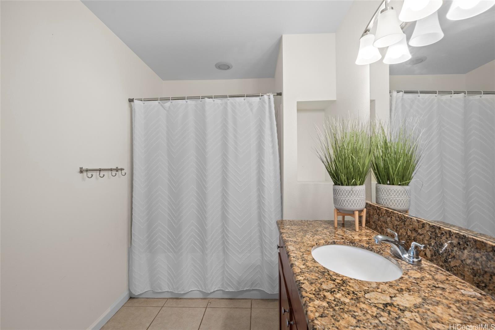 87-176 Maipalaoa Road, Unit D12 Waianae, HI 96792 - Photo 12 of 25 a bath room with a sink and a mirror