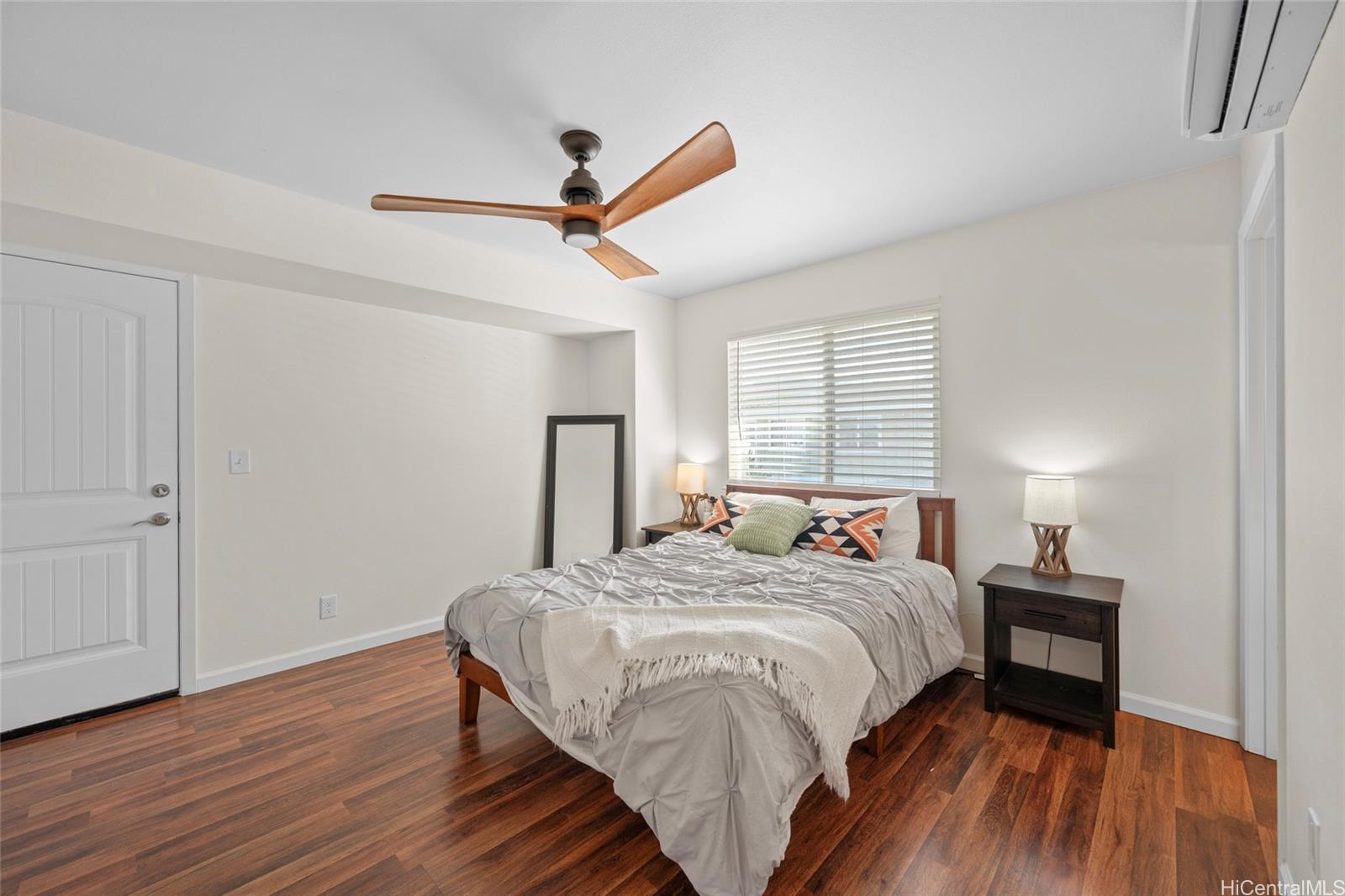 87-176 Maipalaoa Road, Unit D12 Waianae, HI 96792 - Photo 14 of 25 a bedroom with a bed and wooden floor